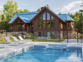 The bright blue metal roof makes the house stand out against the greenery and it echoes the soothing blue of the pool.
