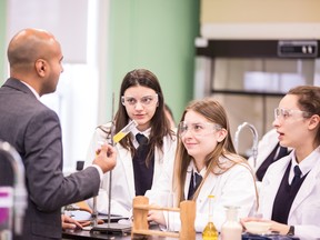 Students hang on science teacher David Reda’s every word in the science lab at Sacred Heart.