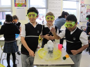 Protective goggles in place, a group of enthusiastic Grade 2 students at Collège Charlemagne tackle a science experiment