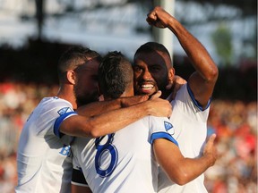 Montreal Impact's Anthony Jackson-Hamel, right, celebrates his goal against Cavalry FC during first half of Canadian Championship semifinal in Calgary on Aug. 14, 2019.