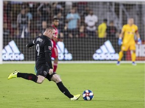 D.C. United forward Wayne Rooney (9) takes a free kick against the New York Red Bulls during the first half at Audi Field Aug. 19.