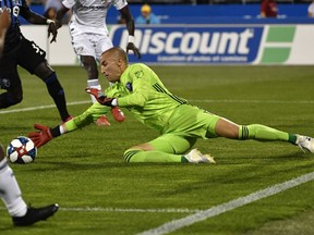 Montreal Impact goalkeeper Evan Bush makes a save against FC Dallas during the second half of the game at Stade Saputo.