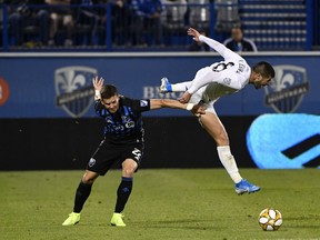 D.C. United midfielder Ulises Segura (8) collides with Impact defender Jukka Raitala at Saputo Stadium in Montreal on Saturday, August 31, 2019.