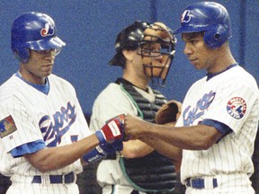 In this photo dated June 25, 1994, Montreal Expos players Moises Alou (right) and Lou Frazier are all business as they celebrate Alou's two-run homer in the second. Frazier was baserunner. Florida Marlins catcher is Ron Tingley.