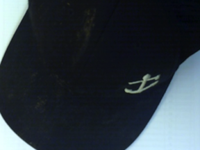 The black baseball cap the suspect was wearing was left at the crime scene. The cap has a boat anchor logo on it.