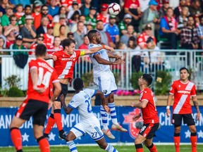 Montreal Impact forward Anthony Jackson-Hamel (11) and Cavalry FC defender Mason Trafford (5) jump for the ball during the first half during the Canadian Championship semi-final match at Spruce Meadows, Alta., on Aug. 14, 2019.