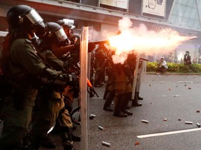 A riot police shoots a tear gas canister during a protest in Tsuen Wan, in Hong Kong, China, August 25, 2019.