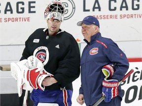 Carey Price has a conversation with head coach Claude Julien during Montreal Canadiens practice at the Bell Sports Complex in Brossard on Jan. 31, 2019.