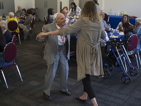 A man named Haskel dances with Michelle Moore-Torman, supervisor for the Drop-In program, at a drop-in centre for seniors in Côte-St-Luc on Wednesday, September 4, 2019, after funding was announced in the amount of $922,025 for the Cummings Centre Therapeutic Dementia Care Program.