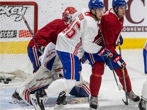 Josh Brook and Liam Hawel look up ice in front of goaltender Cayden Primeau during the Montreal Canadiens rookie camp at the Bell Sports Complexe in Brossard on Friday, Sept. 6, 2019.