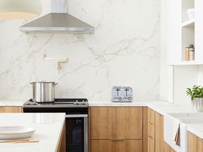 Mixing simple wood and white cabinets, display shelves and lots of durable surfaces are just a few characteristics of a Euro modern kitchen. Stone wall: Dekton Entzo surfacing, Cosentino.com. Photo: Yvonne Duivenvoorden