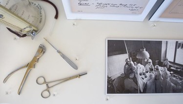 A detail from a display at the MUHC Glen site in Montreal dedicated to pioneering doctor Norman Bethune. The instruments were used by Bethune. The photo on the right shows him and a team in an operating theatre.