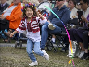 Four-year-old Marine Le runs with a rainbow-coloured ribbon  during the Montreal Ukrainian Festival  Sunday September 8, 2019.