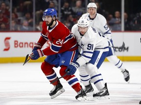 Toronto Maple Leafs centre John Tavares leans on Montreal Canadiens' Phillip Danault in Montreal on April 6, 2019.
