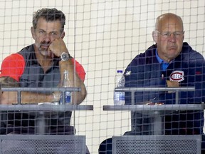 Montreal Canadiens general manager Marc Bergevin, left, and head coach Claude Julien watch team of Habs rookies play against Quebec university all-star team's at the Bell Sports Complex in Brossard on Sept. 10, 2019.