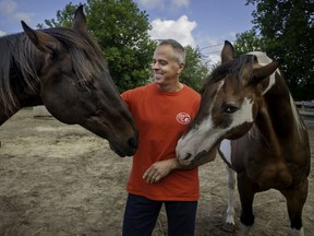 Mike Grenier is seen here with Jack, left, and Buddy at A Horse's Tail rescue in Vaudreuil-Dorion.