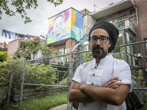 Artist Julian Palma Luque is seen near the mural he painted of Ariel Jeffrey Kouakou, on Wednesday Sept. 11, 2019.