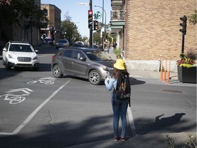 A pedestrian waits for cars to make their way through the intersection of Iberville and Hochelaga Sts. on Thursday, Sept. 12, 2019.