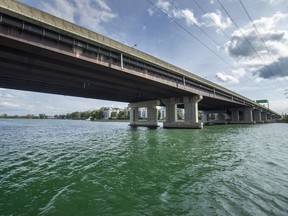 Calm, green water flows under the Galipeault Bridge in Ste-Anne-de-Bellevue, west of Montreal Wednesday September 11, 2019.  The water, normally brown because of outflow from the Ottawa River, has turned green and is flowing in the opposite direction due to higher water levels in the Great Lakes and the St. Lawrence River.
