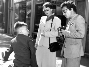 Original cutline for photo, which appeared in the Montreal Gazette on Sept. 14, 1953: Two police constables in plain clothes check up on a young boy who looks as though he should be in school. It was all right he was 14. Two constables in a district work in plain clothes while another two work in uniform. They change positions every three months.
