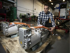 Effenco founder and president David Arsenault inspects electric motors to be shipped to France.