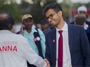 Sameer Zuberi greets a voter outside the Pierrefonds Community High School, Sunday.