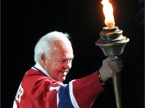 Former Canadiens captain Yvan Cournoyer carries torch on the ice before Game 6 of playoff series against the Boston Bruins at the Bell Centre in Montreal on April 26, 2011.