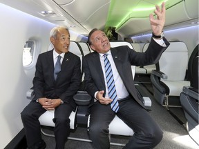 Premier François Legault, sitting in an aircraft mock-up with Hitoshi Iwasa, president of Mitsubishi Aircraft America, hailed the deal as an example of the job creation his government wants to foster.