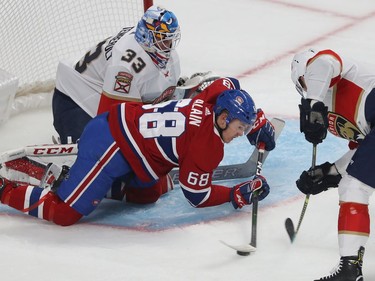 Montreal Canadiens Alexandre Alain tries to control puck in front of Florida Panthers goaltender Sam Montembeault and Florida Panthers' Colton Sceviour (7) during first period NHL exhibition game in Montreal on Thursday September 19, 2019.