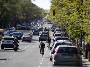 Cyclists ride north on St-Denis St. in May. Merchants say a north-south express “bike corridor” on the street would create a business disaster, while pro-bike spokespeople argue it would help save the street, because “bikers shop, too.”