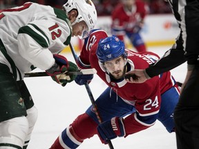 Canadiens centre Phillip Danault and Wild centre Eric Staal wait for the linesman to drop the puck. Danault won 55.5 per cent of his faceoffs last season and hopes to improve again this year.