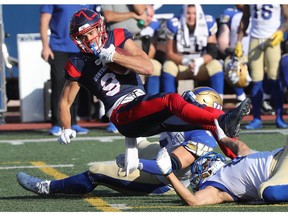 Alouettes's Jake Wieneke (9) is brought down by players of the Winnipeg Blue Bombers during first half CFL action in Montreal on Saturday, Sept. 21, 2019.