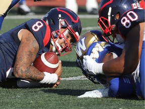 Alouettes quarterback Vernon Adams Jr. (8) grimaces after being sacked by Winnipeg Blue Bombers's Willie Jefferson (5) in Montreal on Saturday, Sept. 21, 2019.