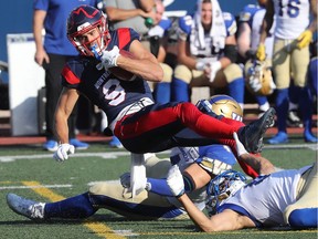 Montreal Alouettes' Jake Wieneke is brought down by Blue Bombers during first half in Montreal on Sept. 21, 2019.