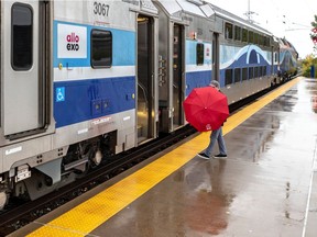 A passenger boards the train at Ahuntsic station on the Mascouche commuter line.