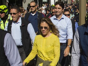 Prime Minister Justin Trudeau and his wife, Sophie Grégoire, are surrounded by security as they take part in the climate march on Friday, Sept. 27, 2019 in Montreal.