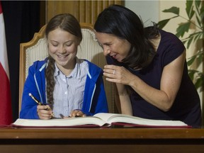 Swedish climate activist Greta Thunberg signs Montreal's Golden Book alongside Mayor Valérie Plante.