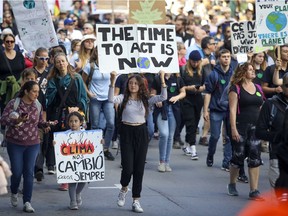 Protesters walk down St-Laurent Blvd. during a climate march in Montreal Sept. 27, 2019.