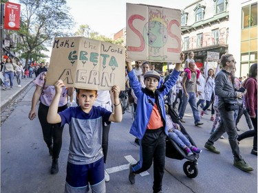 Milan Penners, left, and Malik Bigras take part in climate march in Montreal on Friday, Sept. 27, 2019.