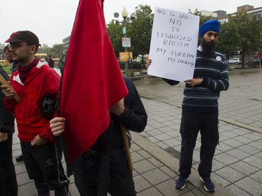 Harjinder Singh holds a sign at a rally against Bill 21 in Montreal on Saturday.