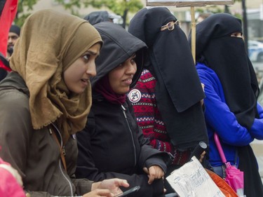 From the left: Sheerose Pardhan, Sarah Khan, Zakia Khan and Sidra Naeem listen to a speaker at a rally against Bill 21 in Montreal on Saturday.