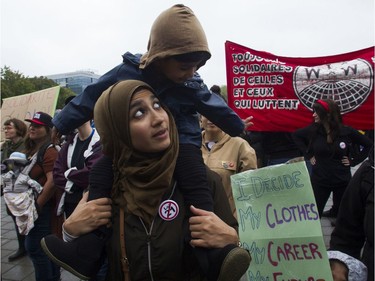 Sheerose Pardhan, with her son Elias Uddin, attend a rally against Bill 21 in Montreal on Saturday.