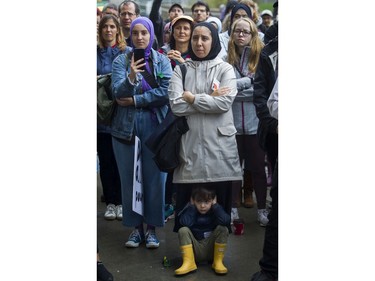 Nada Nour, with her son Omar, and others listen to a speaker at a rally against Bill 21 in Montreal on Saturday.
