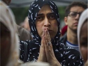 Naima Amrouche listens to a speaker at a rally  against Bill 21 in Montreal on Saturday.