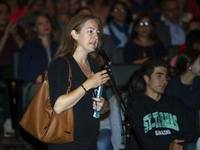 Sonia Bretter, mother of two St. Thomas High School students, asks a question at a town hall meeting to discuss possible school changes within the Lester B. Pearson School Board on Sept. 25.