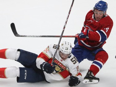 Montreal Canadiens Nick Suzuki (14) and Florida Panthers Jake Massie (56) go down on the ice after colliding during second period NHL exhibition game in Montreal on Thursday September 19, 2019.