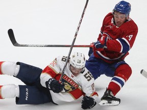 Montreal Canadiens prospect Nick Suzuki and Florida Panthers' Jake Massie go down after colliding during second period in Montreal on Sept. 19, 2019.