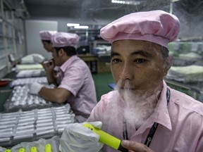 A worker tests an e-cigarette on the production line at Kanger Tech, one of China's leading manufacturers of vaping products, on September 24, 2019 in Shenzhen, China. "We're conducting a big, uncontrolled and poorly documented set of chemistry experiments inside people's lungs," said one researcher.