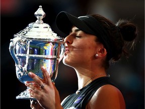 Bianca Andreescu kisses the championship trophy after defeating Serena Williams in the U.S. Open women's singles final on Saturday, Sept. 7, 2019.