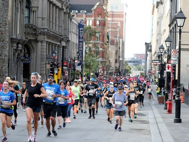 MONTREAL, QUEBEC - SEPTEMBER 22:  Runners along Notre-Dame St. in Old Montreal during the Oasis International Marathon de Montreal - Day 2 on September 22, 2019 in Montreal, Canada.